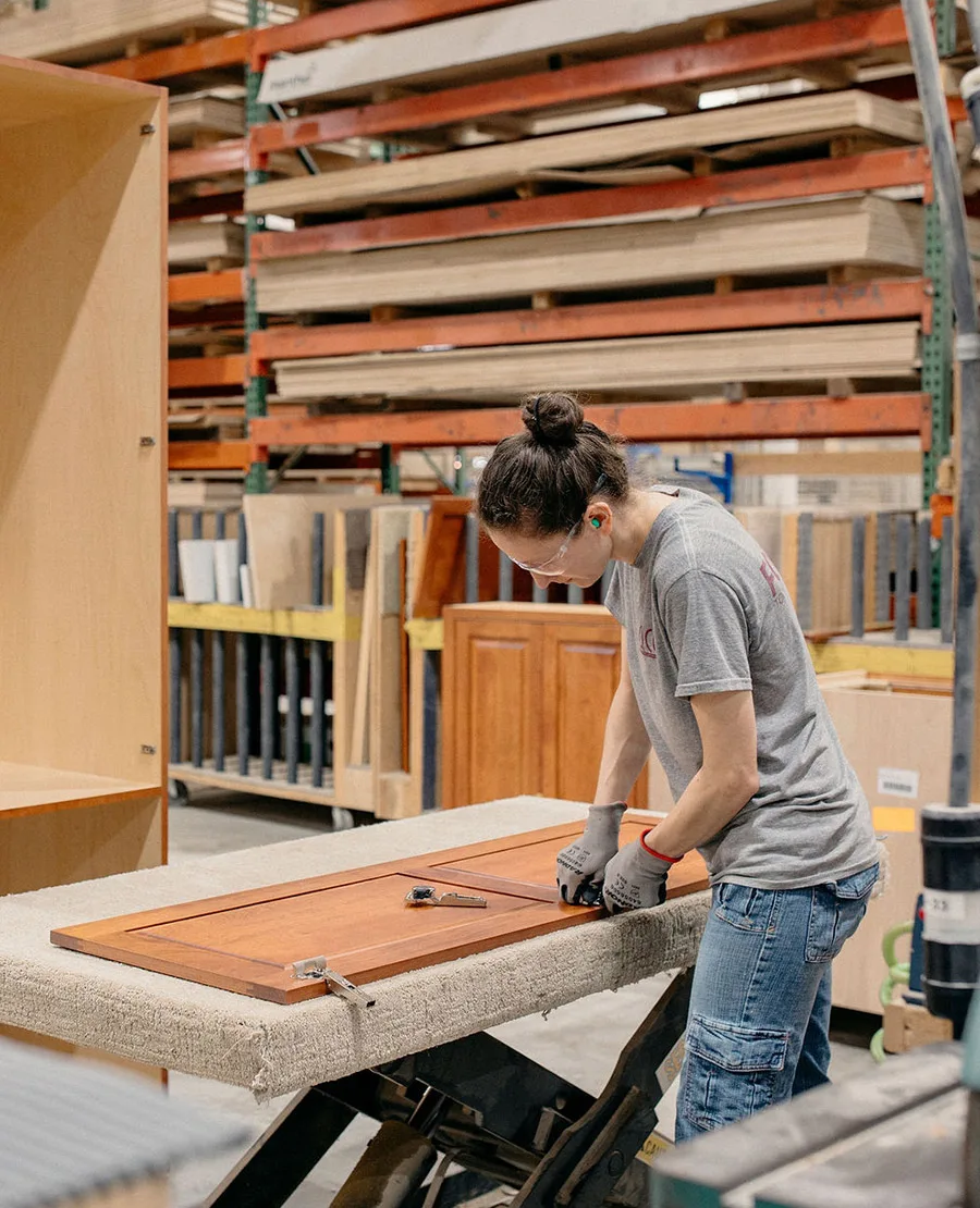 Person assembling cabinets in the QCCI shop