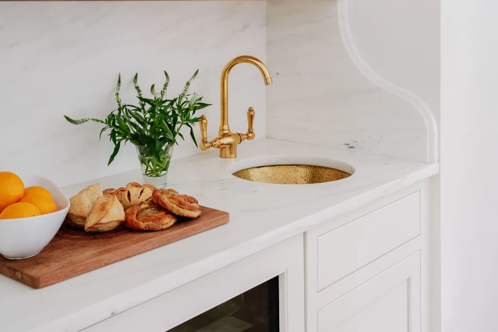 Cabinets with gold faucet and sink