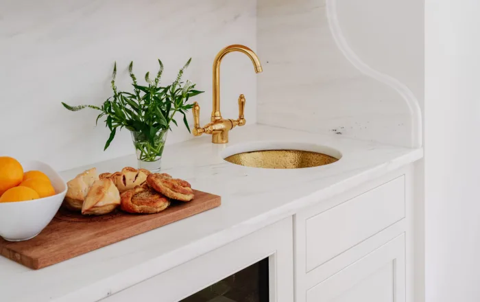 Cabinets with gold faucet and sink