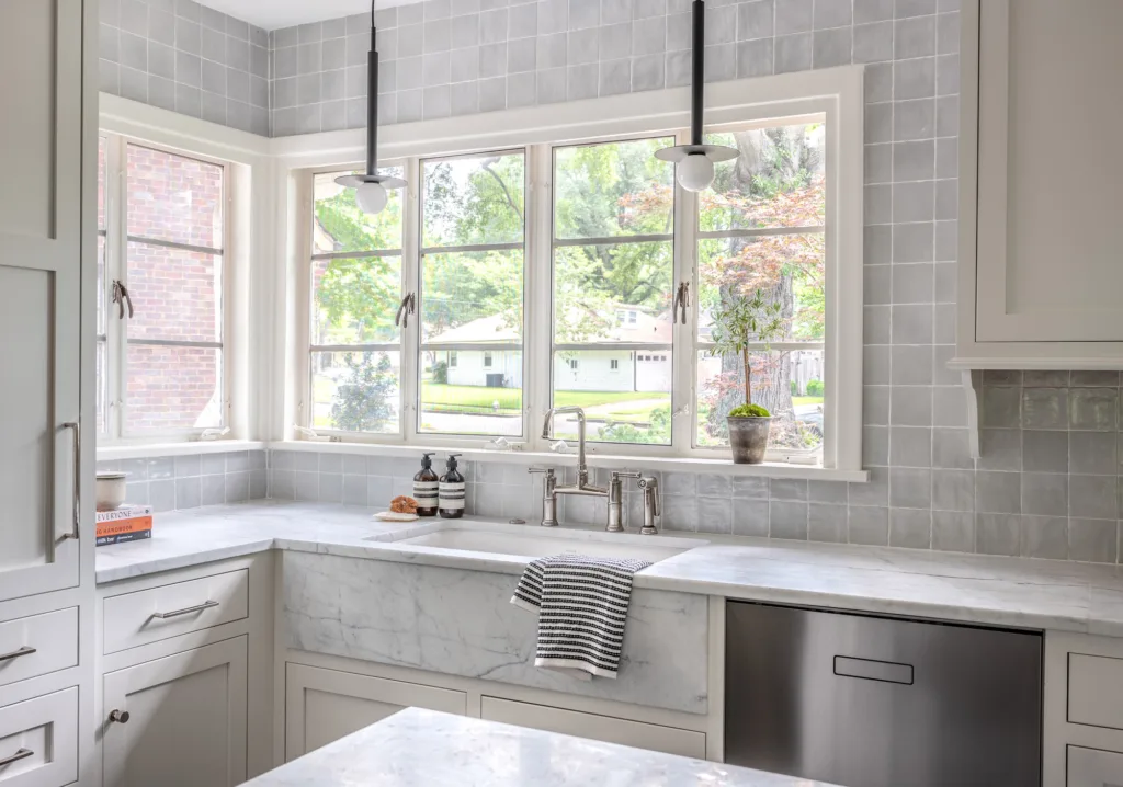 Kitchen with large windows and semi-custom painted kitchen cabinets